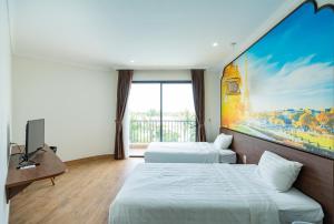 a hotel room with two beds and a painting on the wall at KHÁCH SẠN AQUARIUSGARDEN VÂN LONG NINH BÌNH in Ninh Binh