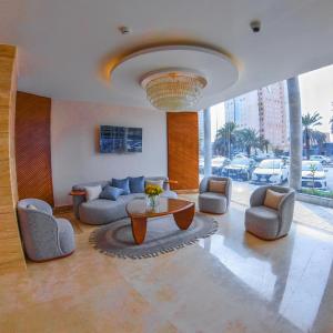 a living room with couches and a table in a building at SAMT INN HOTEL فندق سمت إن in Riyadh