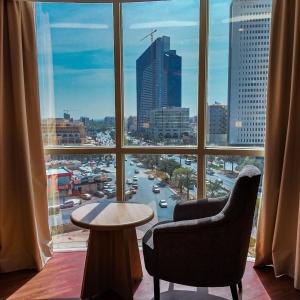 a room with a view of a city from a window at SAMT INN HOTEL فندق سمت إن in Riyadh