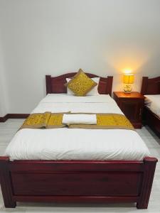 Postel nebo postele na pokoji v ubytování PhaiLin Hotel