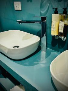 a bathroom with a white sink on a blue counter at Trastevere House in Rome