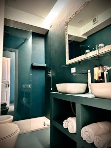 a bathroom with two sinks and a mirror at Trastevere House in Rome