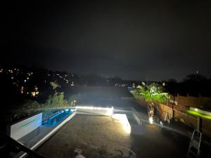a view of a parking lot at night at Luxurious & Elegant 6-Bed House in Barnet