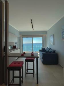 a living room with a table and a couch at Charaki Sea Breeze Modern Studio with Balcony in Haraki