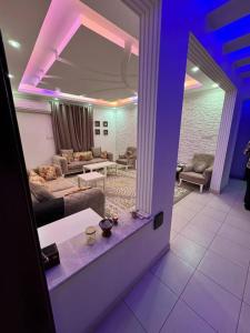 a living room with purple lights on the ceiling at City center 1 bedroom apartment in Muscat