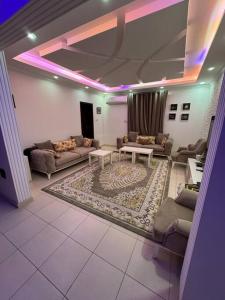 a living room with couches and a rug at City center 1 bedroom apartment in Muscat