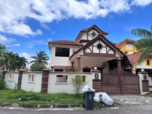 a house with a fence in front of it at Pelangi Indah 8 Rooms Corner Pool Table in Ulu Tiram