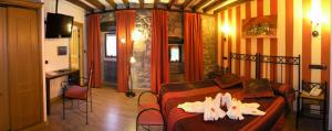 a bedroom with a bed with shoes on it at Posada La Victoria in Miengo