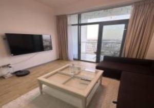 a living room with a couch and a coffee table at Key View - Binghatti Apartments in Dubai