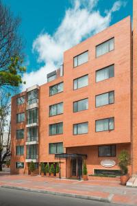 a brick building on a city street at Hotel Saint Simon in Bogotá