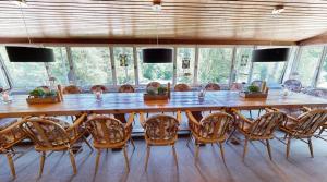 a large wooden table and chairs in a room at Reiterpension Marlie in Scharbeutz