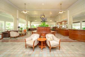 a lobby with chairs and a fountain in the middle at Comsaed River Kwai Resort SHA in Kanchanaburi City