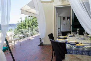 a dining table on a patio with a view of the water at Holiday home Fiorita in Portovenere