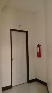 a white door in a room with a fire hydrant at Sharana Pensionne in Davao City