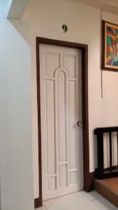 a white door in the corner of a room at Sharana Pensionne in Davao City