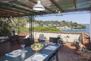 a table on a patio with a view of the ocean at Holiday home Fiorita in Portovenere