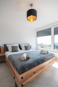Schlafzimmer mit einem Holzbett und einem großen Fenster in der Unterkunft Astonishing villa Blue Horizon w heated pool in Podstrana