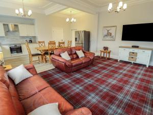 a living room with a couch and a table at Castle Top Haven in Market Rasen