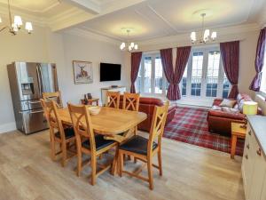 a kitchen and living room with a table and chairs at Castle Top Haven in Market Rasen