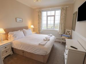 a bedroom with a bed with a teddy bear on it at Castle Top Haven in Market Rasen
