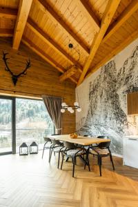a dining room with a table and chairs at CASA IL TRAMONTO Val di Sole in Commezzadura