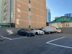 a group of cars parked in a parking lot at Hotel Yam in Busan
