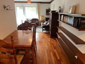 a dining room with a table and a living room at Ferienwohnung Lidia Badbruck in Bad Gastein