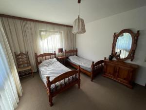 a bedroom with two beds and a mirror at Ferienwohnung Lidia Badbruck in Bad Gastein