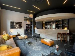 a living room with a couch and a bar at Hotel Elisabeth in Mechelen +106 photos