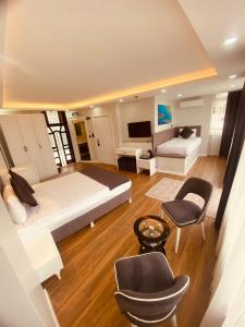 a bedroom with a large bed and a living room at Hodegon Suite Hotel in Istanbul