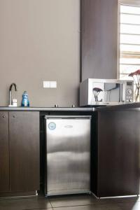 a kitchen with a dishwasher and a microwave at Bright Loft With Terrance - Next to Metro Kerameikos in Athens