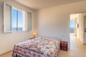 a bedroom with a bed and a view of the ocean at RivieraRent La Terrazza sul mare in Pietra Ligure