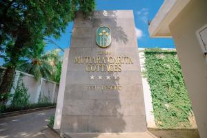 a sign at the entrance to the mountain city coffins at Mutiara Carita Cottages in Carita