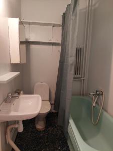 a bathroom with a sink and a toilet and a tub at Home Inn RSG19 in Stockholm