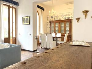 a living room with a table and a dining room at Villa Liberty TownHouse in Siena