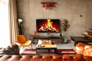 a living room with a couch and a fireplace at NSMA - The Loft experience in Riyadh