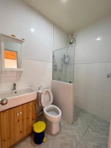 a bathroom with a toilet and a sink and a shower at สต็อกโฮม เขาใหญ่ (StockHome Khao Yai) in Khanong Phra