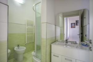 a bathroom with a sink and a toilet and a mirror at B&Brandi - Sweet Dreams in Florence in Florence