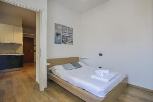 1 Schlafzimmer mit einem weißen Bett und einer Küche in der Unterkunft B&Brandi - Sweet Dreams in Florence in Florenz