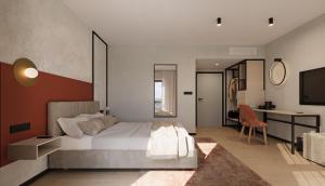 una camera con un grande letto e una scrivania di Hotel Milo Gdansk Airport a Danzica