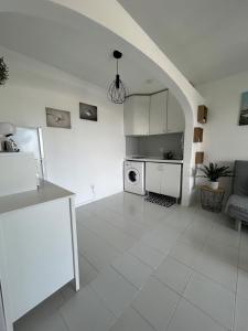 cocina blanca con fogones y microondas en Vista Garden, en Maspalomas