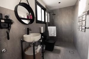 a bathroom with a sink and a mirror at NSMA - The Loft experience in Riyadh