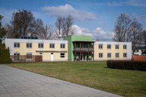 a large white building with a green roof at Garni hotel Svitavy in Svitavy