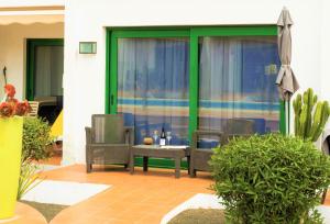 a patio with two chairs and a table on a patio at Beautiful One Bedroom Ground Floor Apartment - VeraLuna in Tías