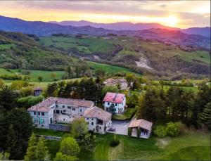 an estate in the hills with the sunset in the background at B&B CorteBonomini entire home 