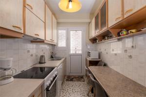 a kitchen with a sink and a counter top at Alimos Marina Sunnyhub in Athens