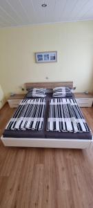 a large bed in a room with a wooden floor at Ferienwohnung Jo Secco in Bruttig-Fankel