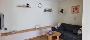 a living room with a couch and a table at Ferienwohnung Jo Secco in Bruttig-Fankel