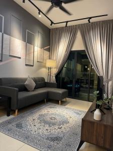 a living room with a couch and a table at Reizz Residence By Nexus Suites in Kuala Lumpur