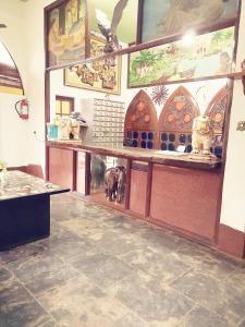 a restaurant with a counter with a animal on it at Falcon Resorts by Dia Hotels in Calangute